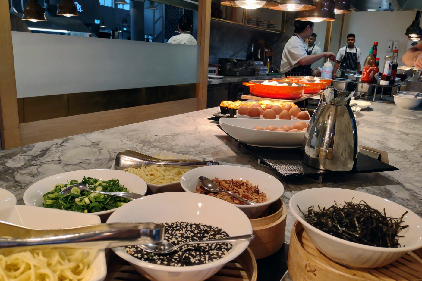 noodles, sesame seeds, fried onions, scallions or spring onions on the buffet