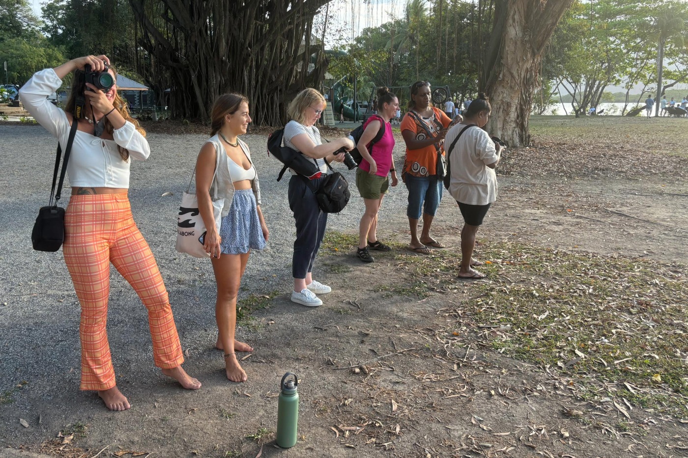 small group of people taking photos on a walking tour in Port Douglas Australia