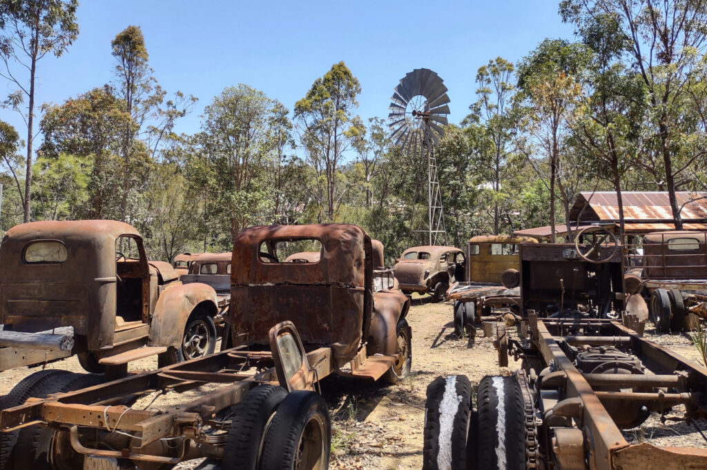 rusty old vehicles, cars, trucks and windmills, at Herberton Historic Village.