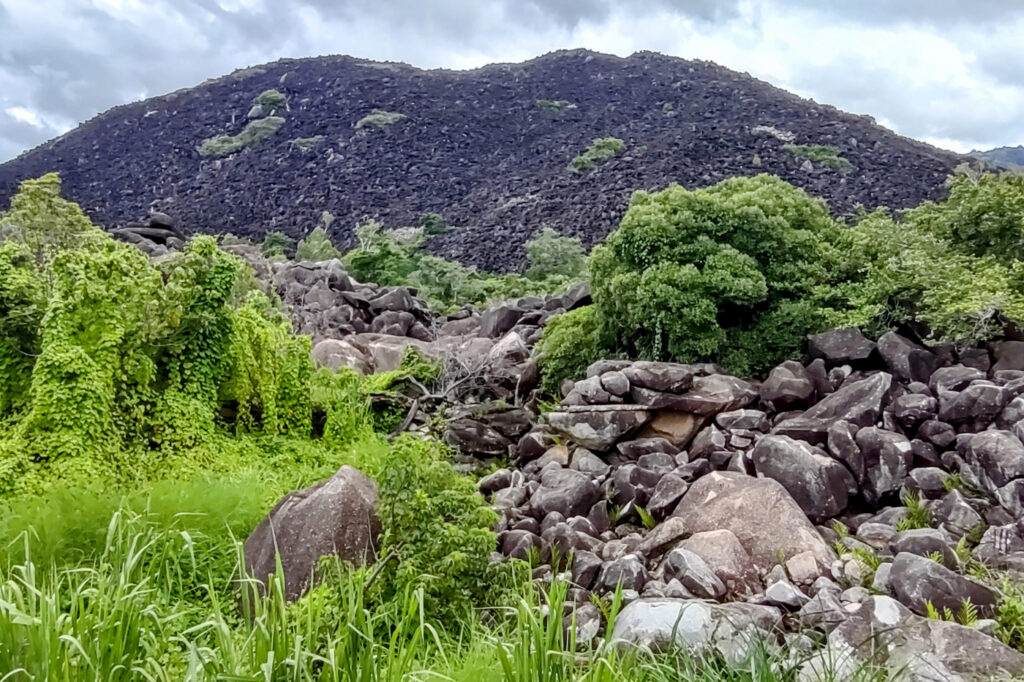 black mountain made of piled up black rocks