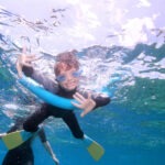 child swimming on The Great Barrier Reef near Cairns