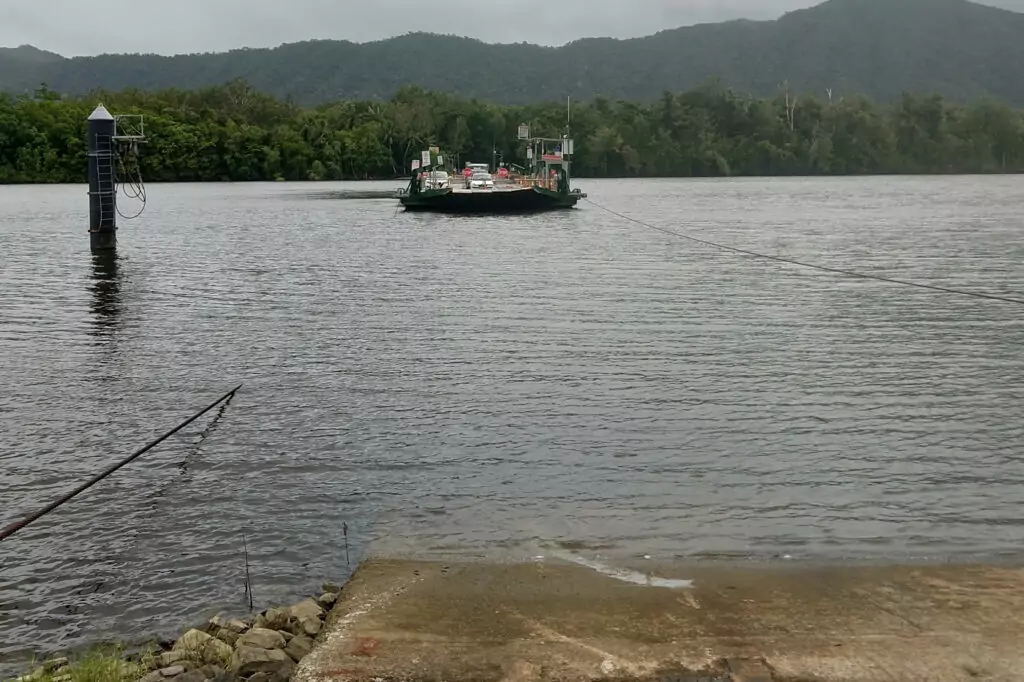 The Daintree Ferry on a wet cloudy day. Cars crossing the Daintree River.